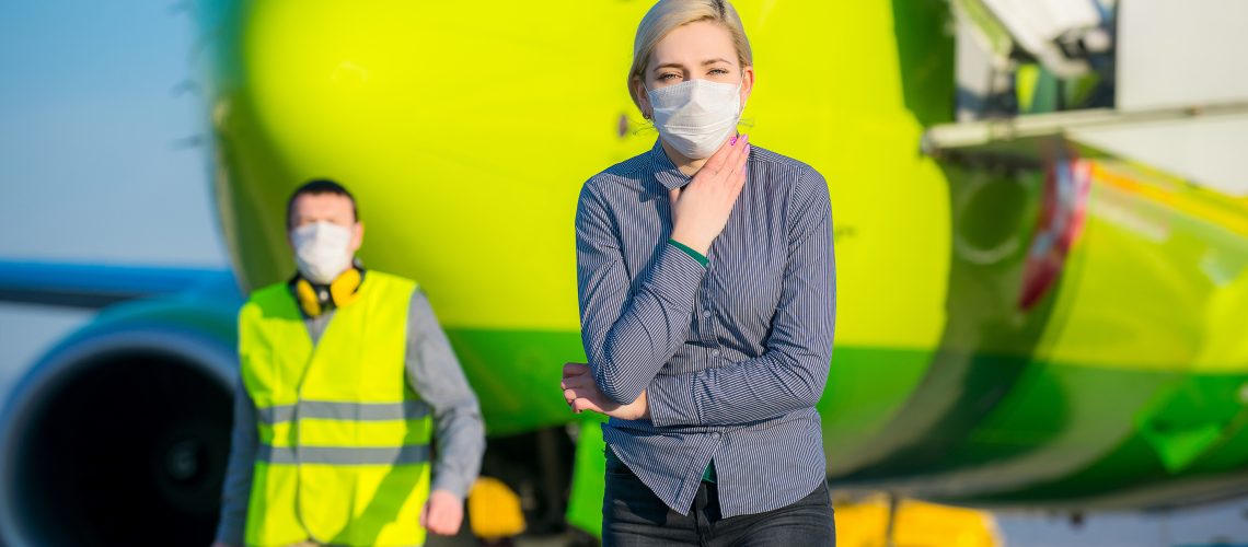 Sick traveling tourist at an airport with mask on the face