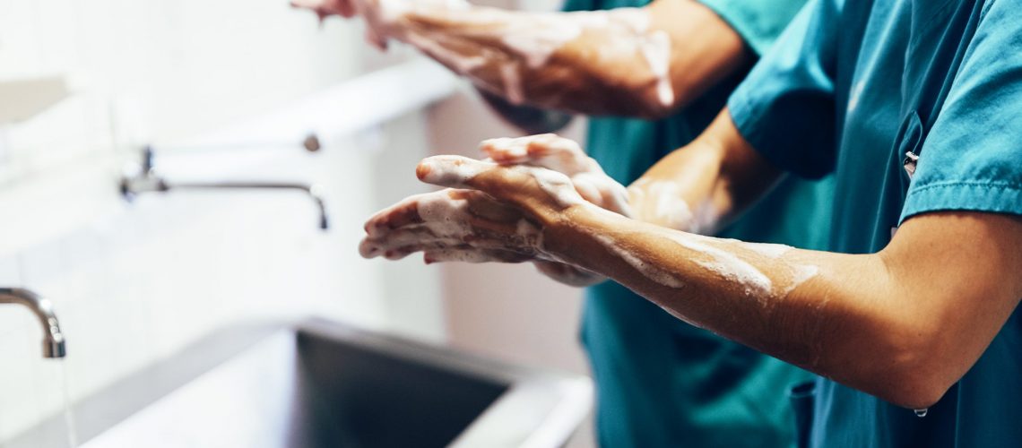 Couple of Surgeons Washing Hands Before Operating. Hospital Concept.