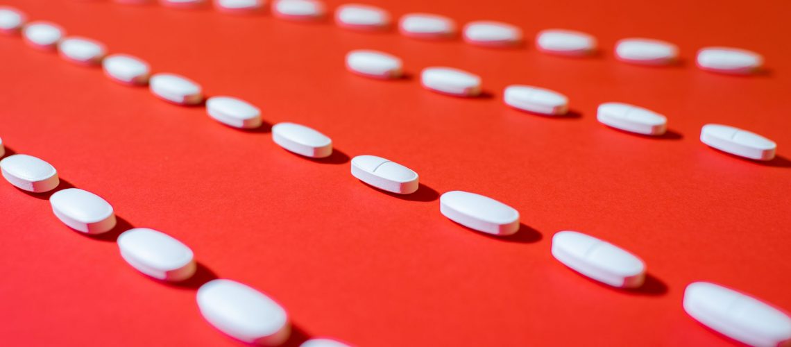 Pile of white pills. Antibiotics resistance. Drug use with reaso
