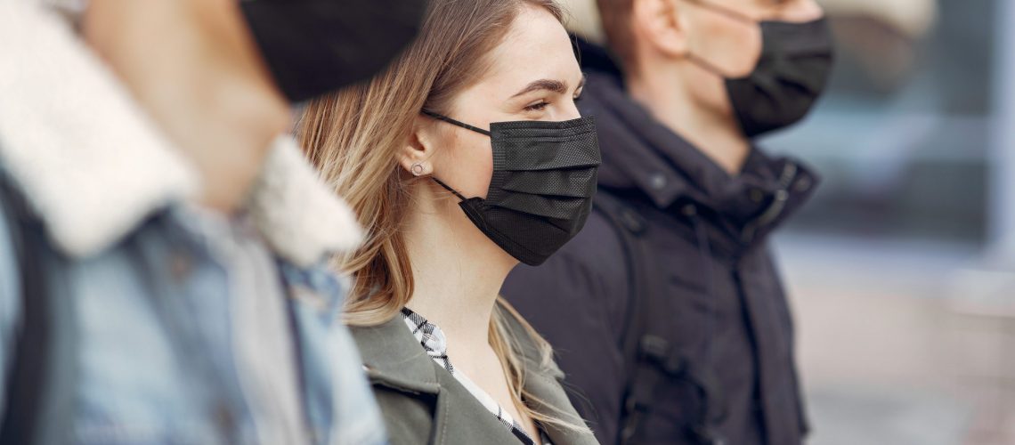 People in the city. Persons in a masks. Coronavirus theme. Friends walks during quarantine.